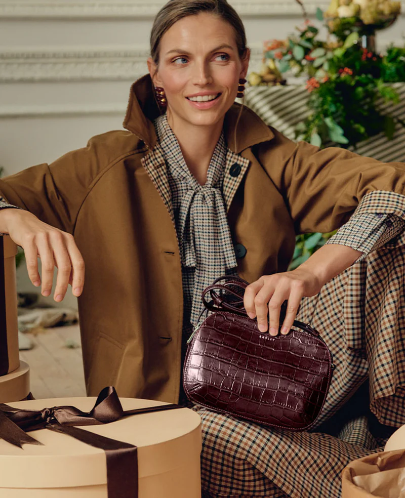 Model holding a Radley London handbag