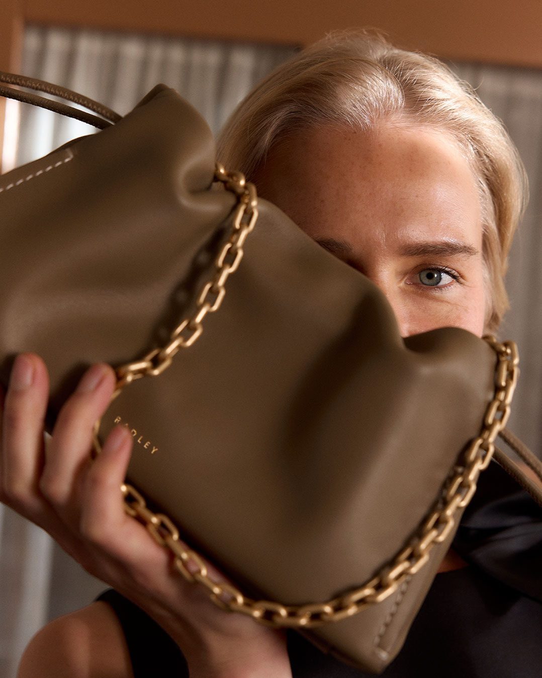 Model holding a Radley London handbag